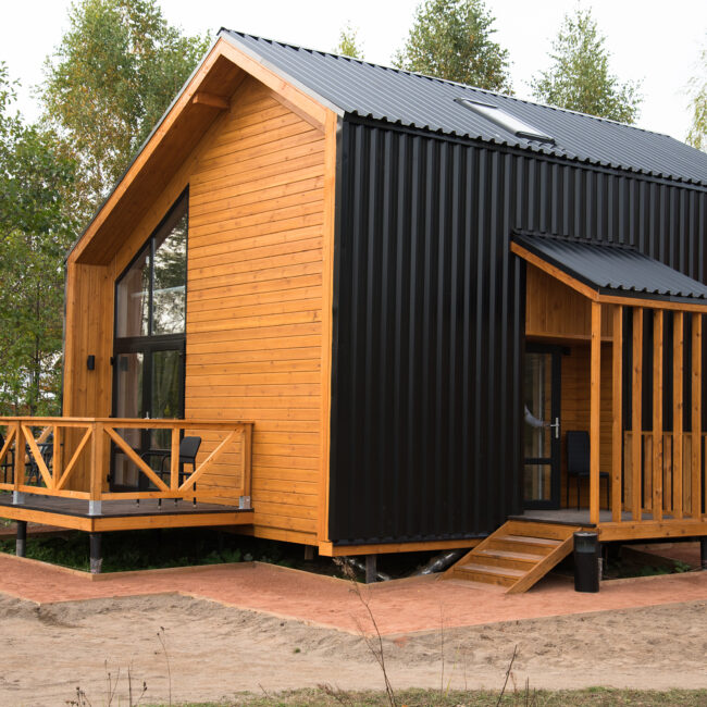 Barnhouse style house. House in the bosom of nature. Greenery and trees.