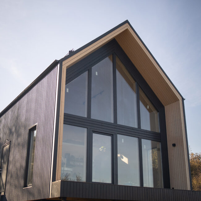 Barnhouse, Barn house. Wooden secluded house in the Scandinavian and Finland modern style with large windows. Exterior.